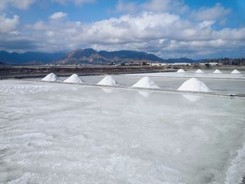 Built structure in water against cloudy sky