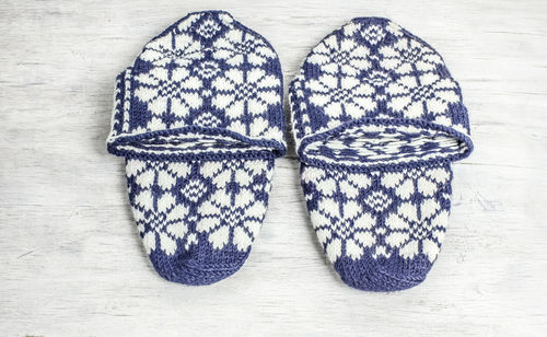 Close-up of woolen shoes on wooden floor