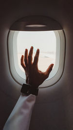 Cropped image of person against window