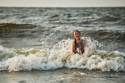 Rear view of man swimming in sea