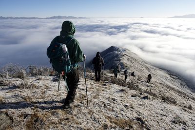 Rear view of man standing on mountain