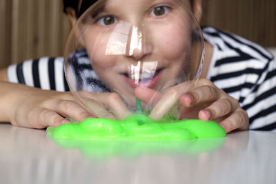 Cropped hand of woman blowing bubbles