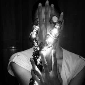 Close-up of woman holding illuminated lamp