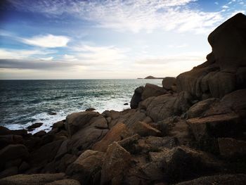 Scenic view of sea against cloudy sky