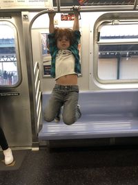 Full length of man traveling in train