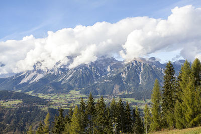 Scenic view of mountains against cloudy sky