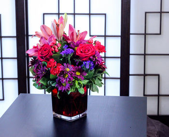 Close-up of pink flower vase on table