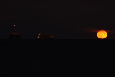 Scenic view of sea against sky at night