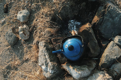 High angle view of old machine on rock