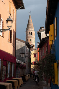 People on street amidst buildings in city