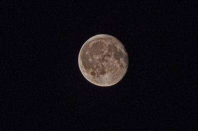 Low angle view of moon against clear sky at night