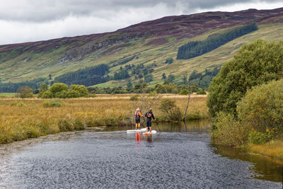 Paddleboarding lesson on the river quaich, scotland.