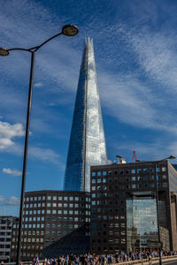 Low angle view of buildings against cloudy sky