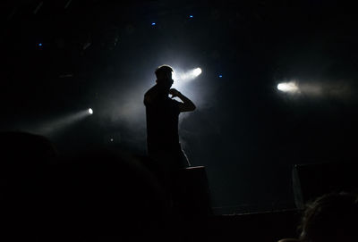 Full length of silhouette man standing at night