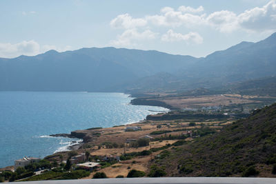 Scenic view of sea and mountains against sky