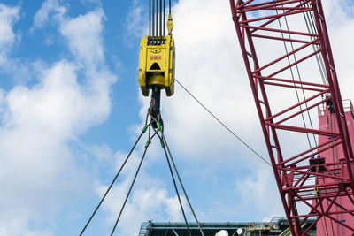 Crane on board a construction work barge performing lifting at oil field