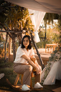 Portrait of a smiling young woman sitting outdoors