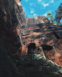 Low angle view of rock formation against sky