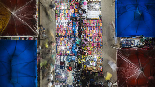 High angle view of various objects for sale at market stall at night