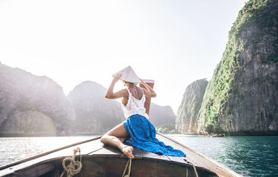 Woman on longtail boat in sea