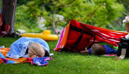 Kids sleeping on grass at park