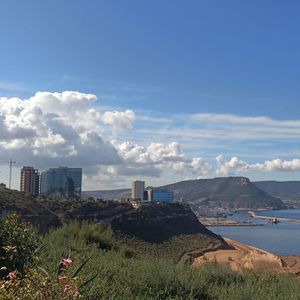 Scenic view of sea and buildings against sky