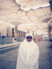 Portrait of woman wearing sunglasses standing outdoors