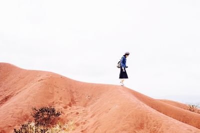 Woman standing on arid landscape