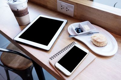 High angle view of coffee and laptop on table