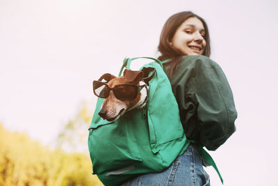 Portrait of a smiling young woman standing outdoors