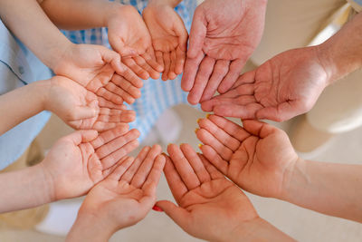 Large european family holding hands together close-up. happy family of five