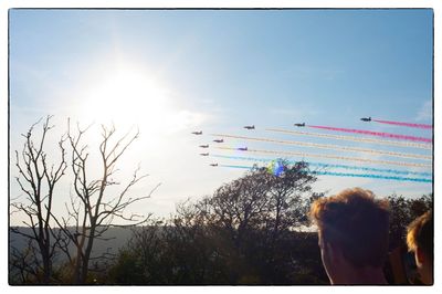 Rear view of people enjoying against clear sky