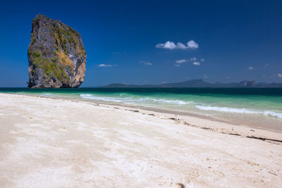 Scenic view of beach against blue sky