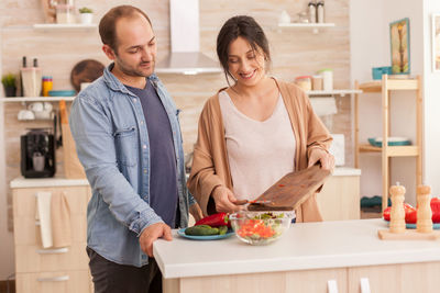 People holding food in restaurant at home