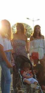 People in traditional clothing against sky during sunset