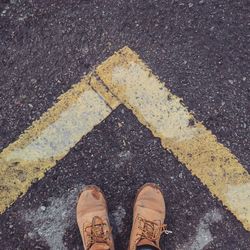 Low section of man standing on road