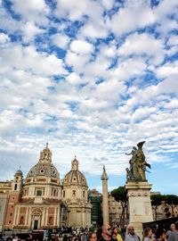 Statue of cathedral against cloudy sky