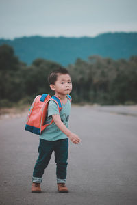 Portrait of smiling boy standing on shore