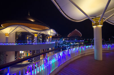 Illuminated bridge in city at night