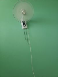 Low angle view of electric fan on wall