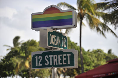 Low angle view of road sign against trees