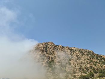 Low angle view of rock formation against sky