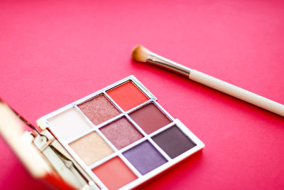 Close-up of beauty products against yellow background