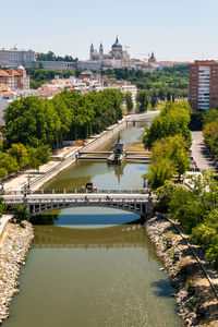 High angle view of bridge over river by buildings in city