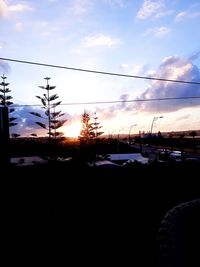 Silhouette trees against sky during winter