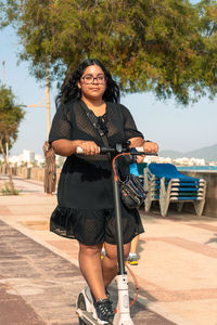 Portrait of young woman sitting on beach