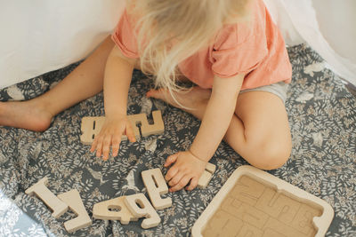 Girl solving wooden puzzles