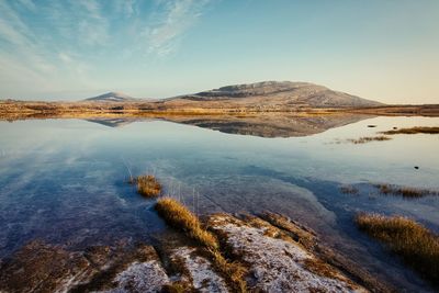 Morning landscape scenery, mountains reflected in lake at burren, county clare, ireland