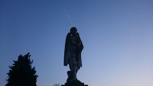 Low angle view of statue against clear blue sky