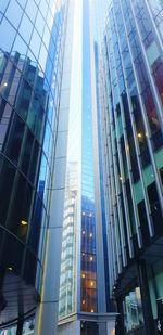 Low angle view of modern buildings in city against sky